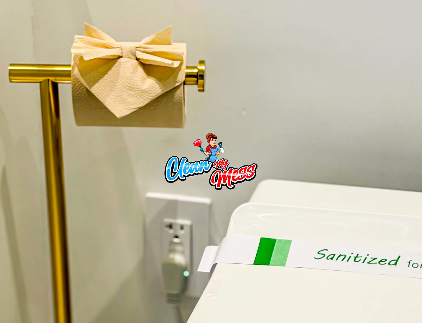 Papel higiénico doblado en una barra dorada junto a un sello de sanitizado
